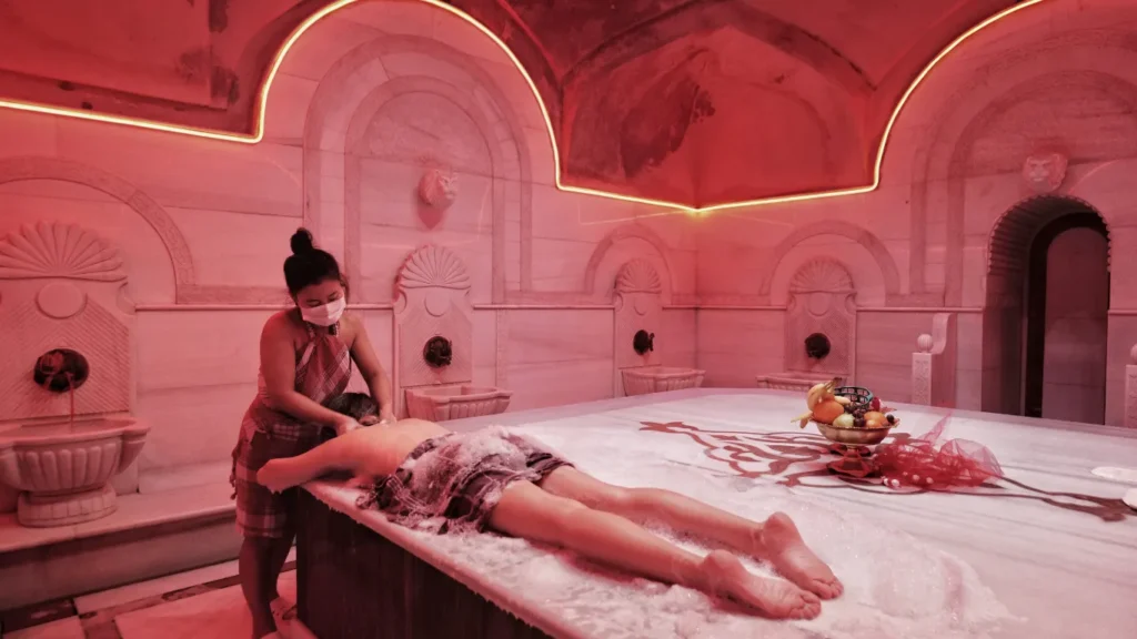 Romantic Turkish bath in Istanbul for two with rose petals and soft lighting