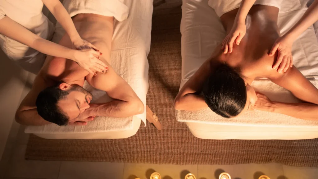 Aromatherapy oils and candles set up for couples spa