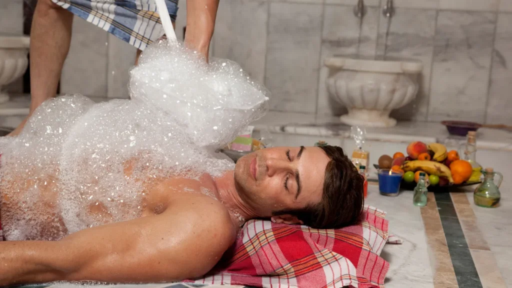 Couple enjoying private hammam with foam massage