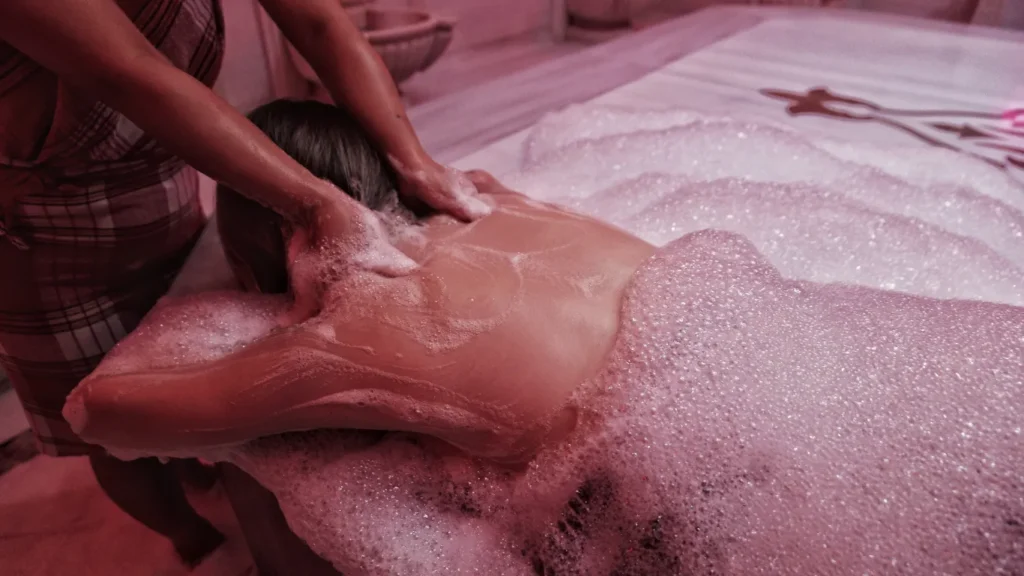 Couple experiencing traditional foam massage in hammam
