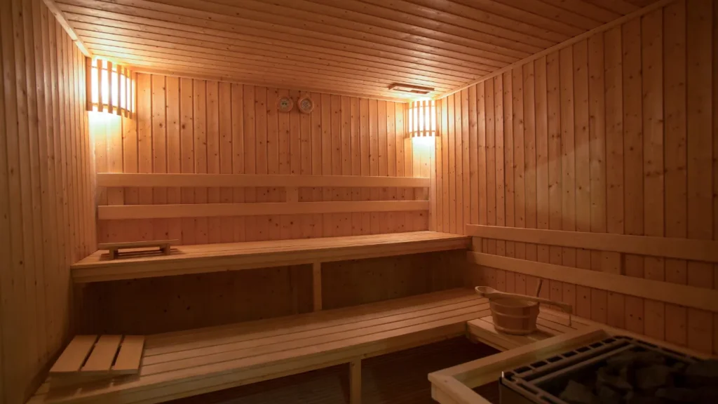 Wooden sauna benches with glowing hot stones.
